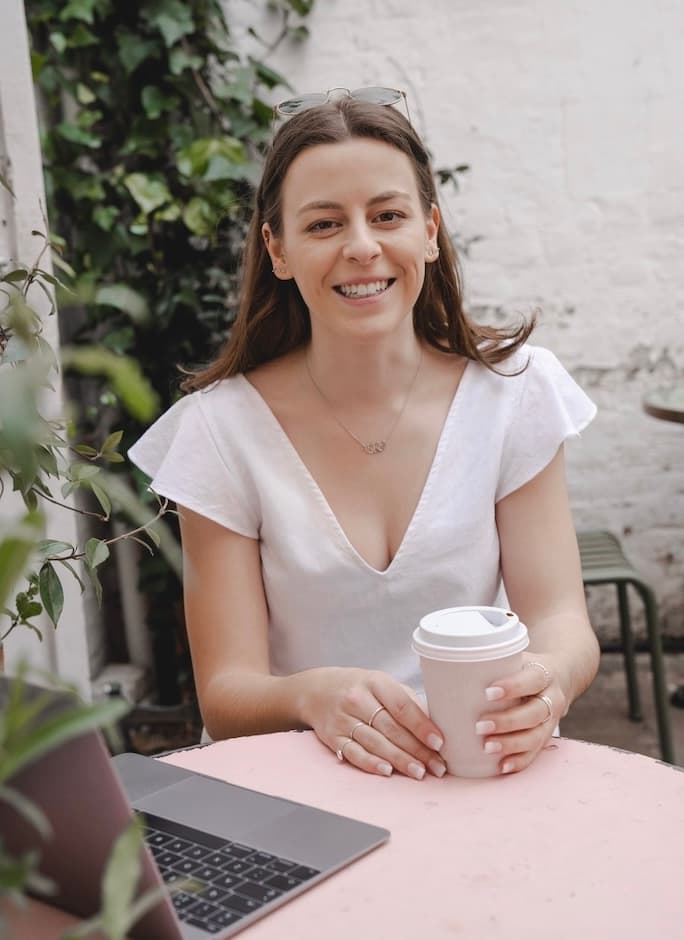 Sofia in a coffee shop on her laptop